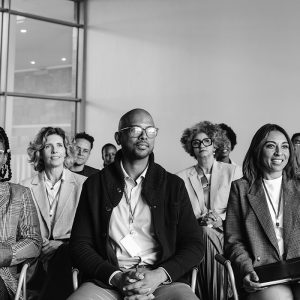 A photo of a diverse group of people listening to a lecture